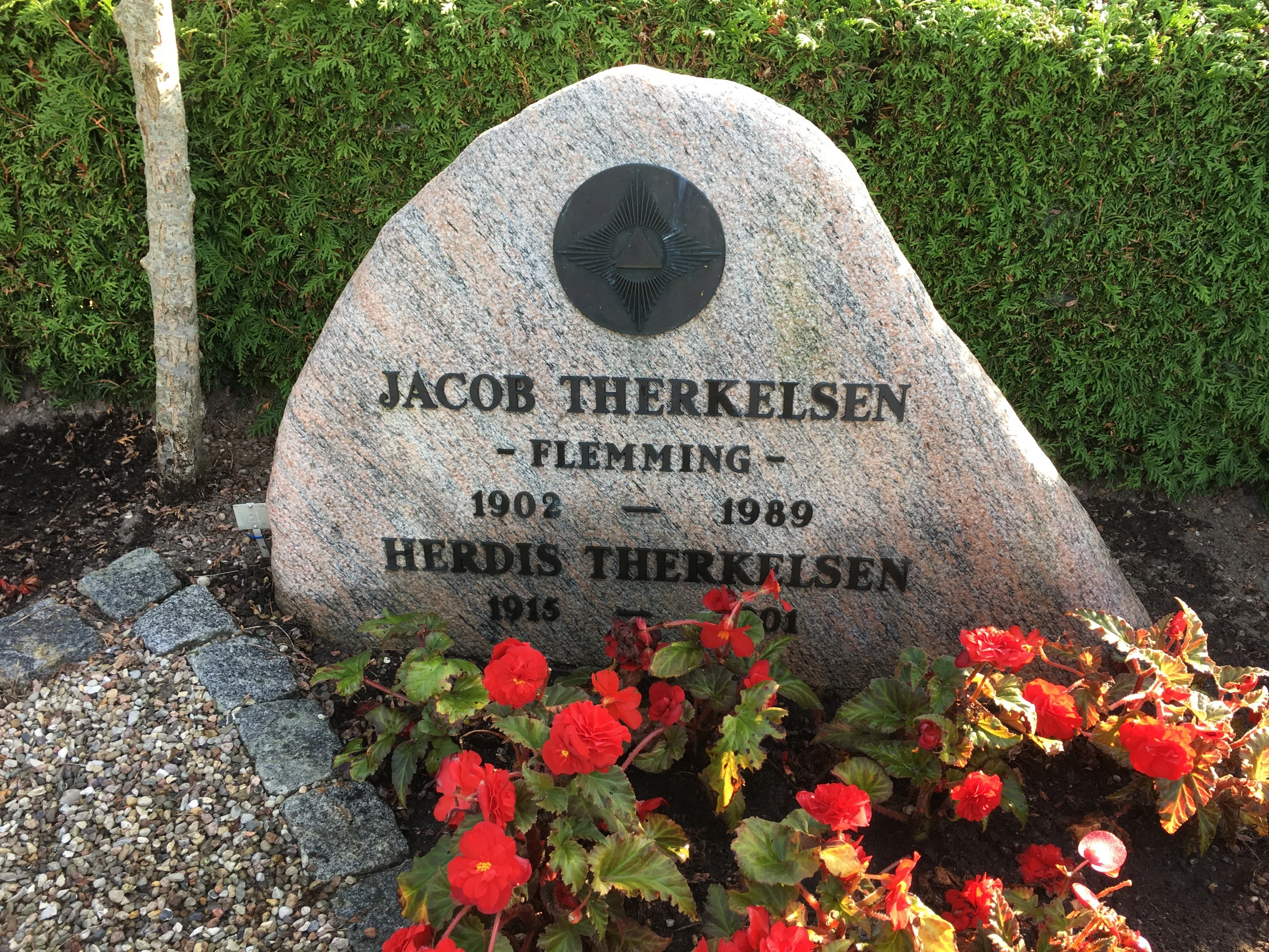 Ole Therkelsen. Familiegravsted Hornborg Kirke. gravsten med Martinus symbol 42, strålekorset, det levende væsen, det evigt levende levende univers. © Martinus Institut. www.martinus.dk Gravsten med Martinus' symbol 42, strålekorset, et symbol på det evigt levende væsen, det evigt levende univers.